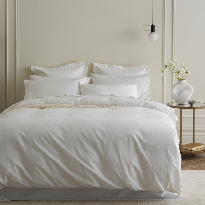 Quilt cover set on a neatly made bed with layered pillows